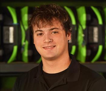 SERVPRO employee in black polo posing for crew photo.