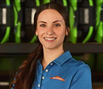 SERVPRO employee in blue polo posing for crew photo.